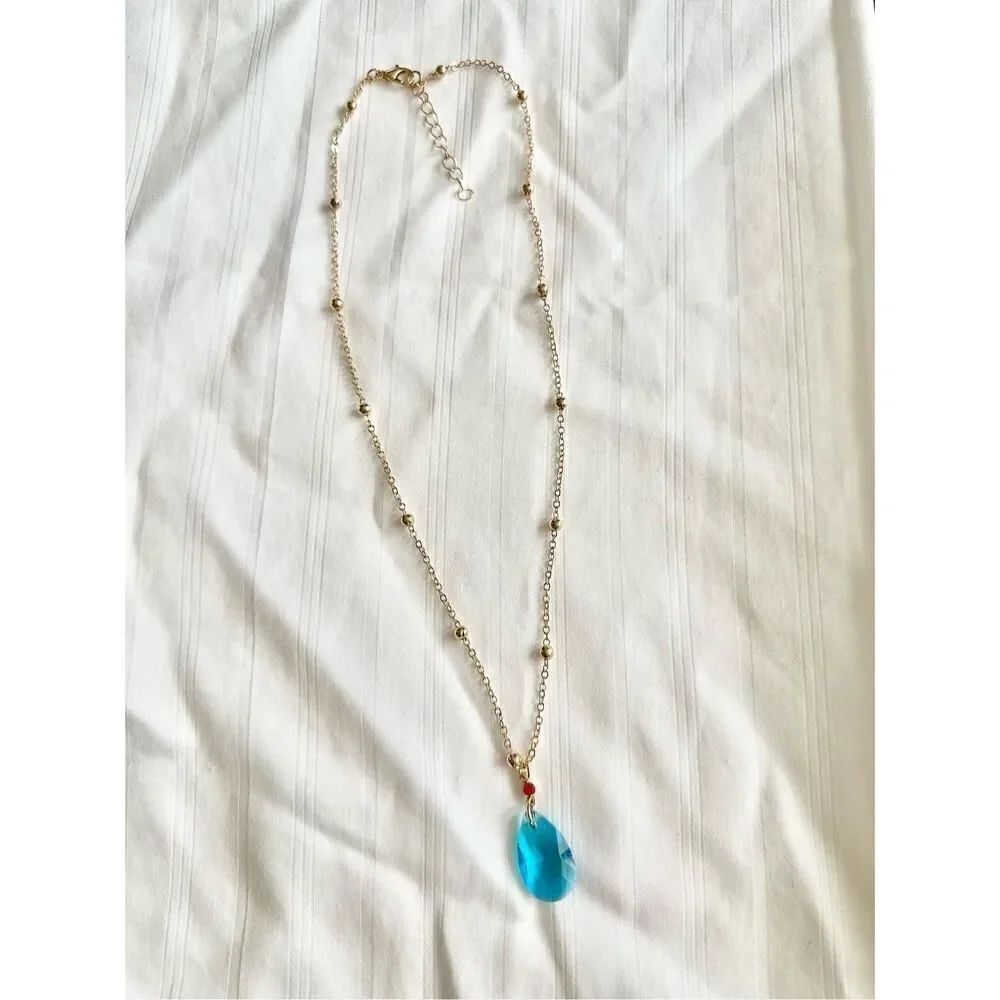 Bright blue teardrop pendant necklace with red CZ